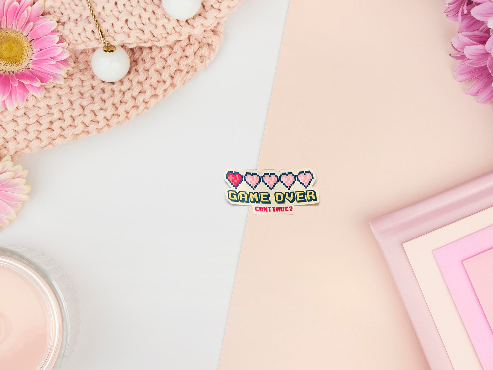 A peelable sticker of depleted pixelated health hearts and the text Game Over Continue?