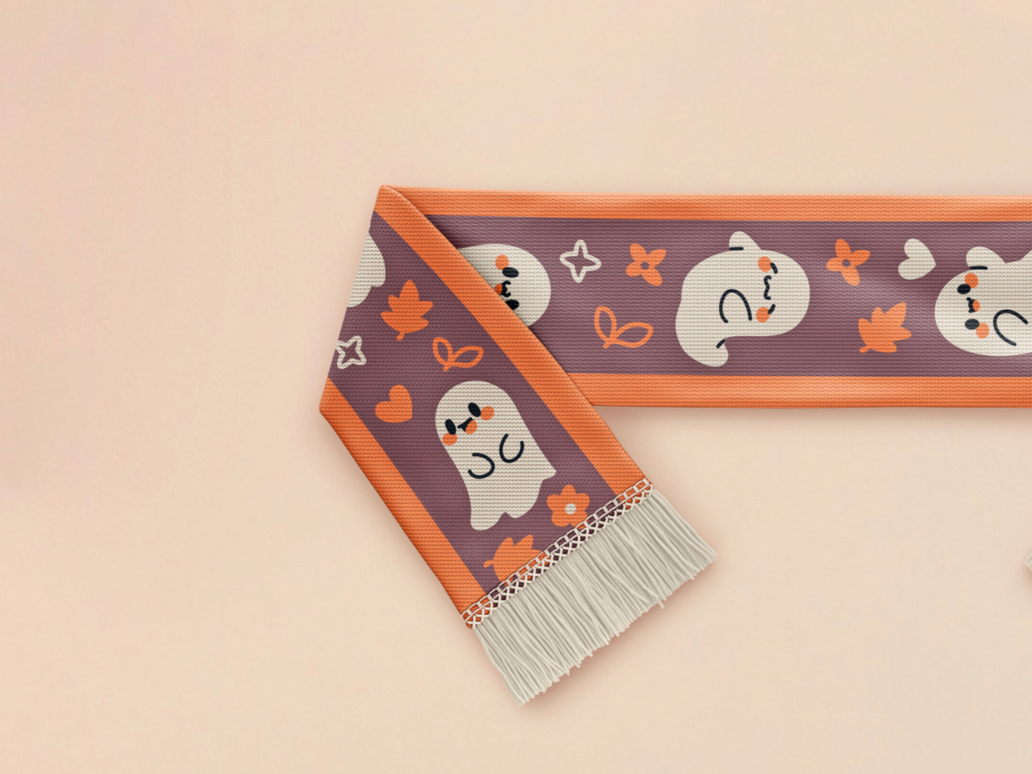Cute knitted cotton scarf with fringe details and an autumn ghost themed pattern