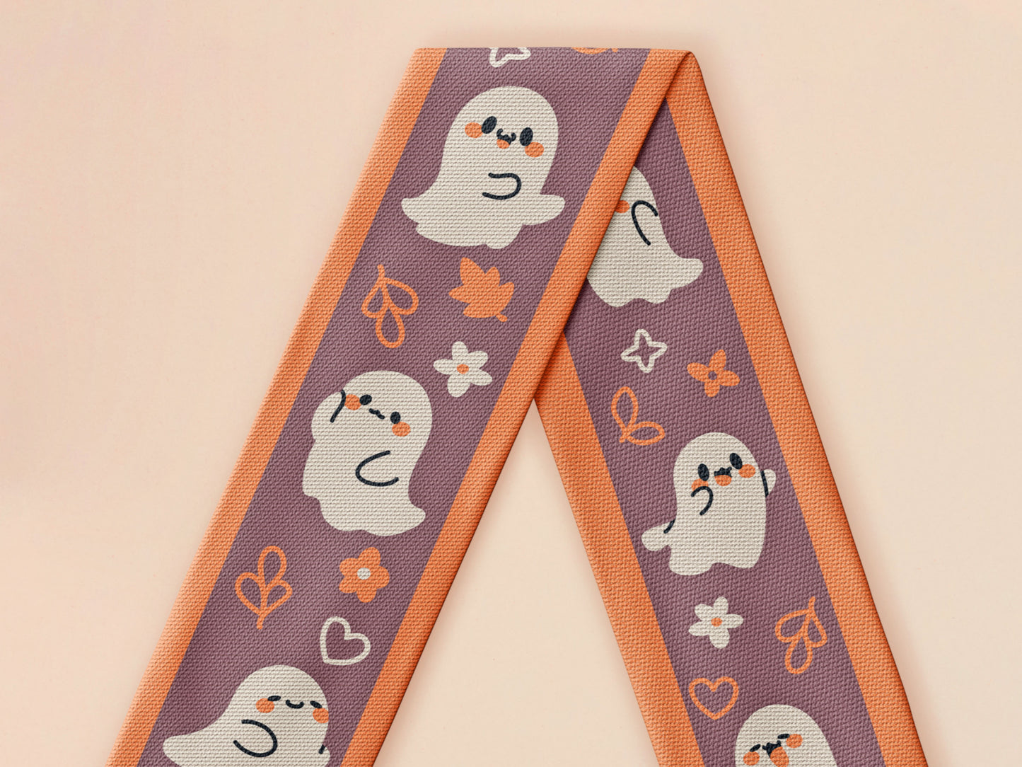 Cute knitted cotton scarf with fringe details and an autumn ghost themed pattern