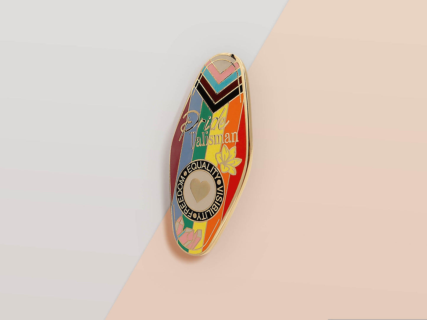 Gold Enamel Talisman Pin with progress pride flag design and the words Pride Talisman, Freedom Equality Visibility. The pins design includes a heart, flowers and crystals.
