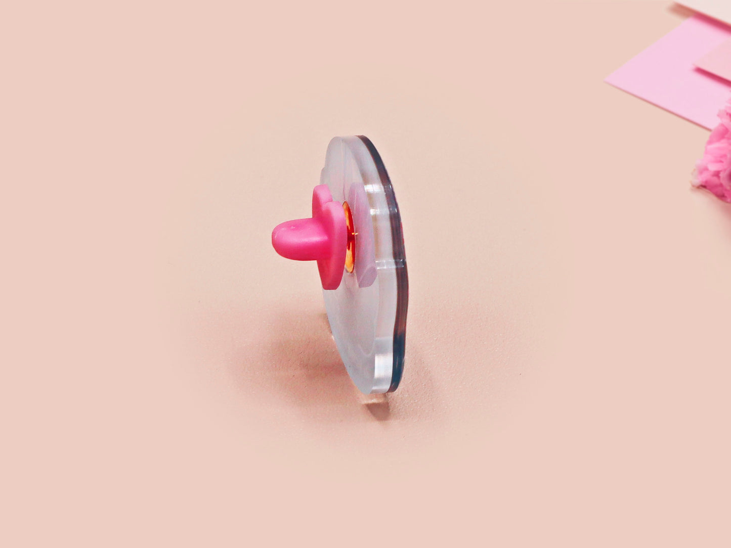 Clear acrylic pin badge with pink heart-shaped rubber pin back clasp. The design of the pin badge is a cute cartoon chibi Mothman cryptid with the quote I believe in Mothman and Mothman believes in me.