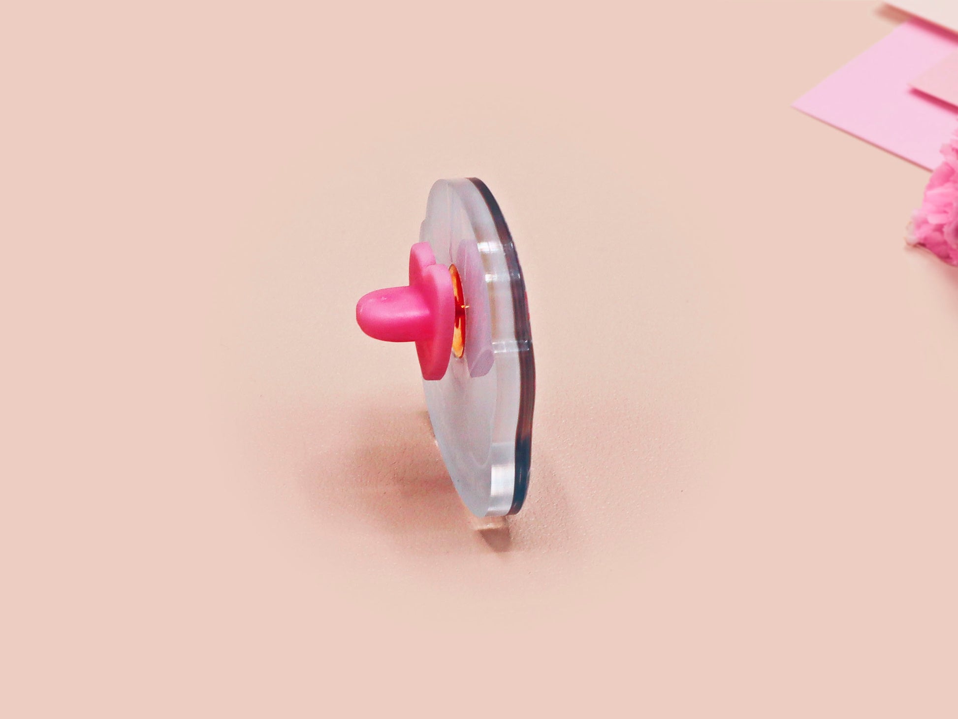 Clear acrylic pin badge with pink heart-shaped rubber pin back clasp. The design of the pin badge is a cute cartoon chibi Mothman cryptid with the quote I believe in Mothman and Mothman believes in me.