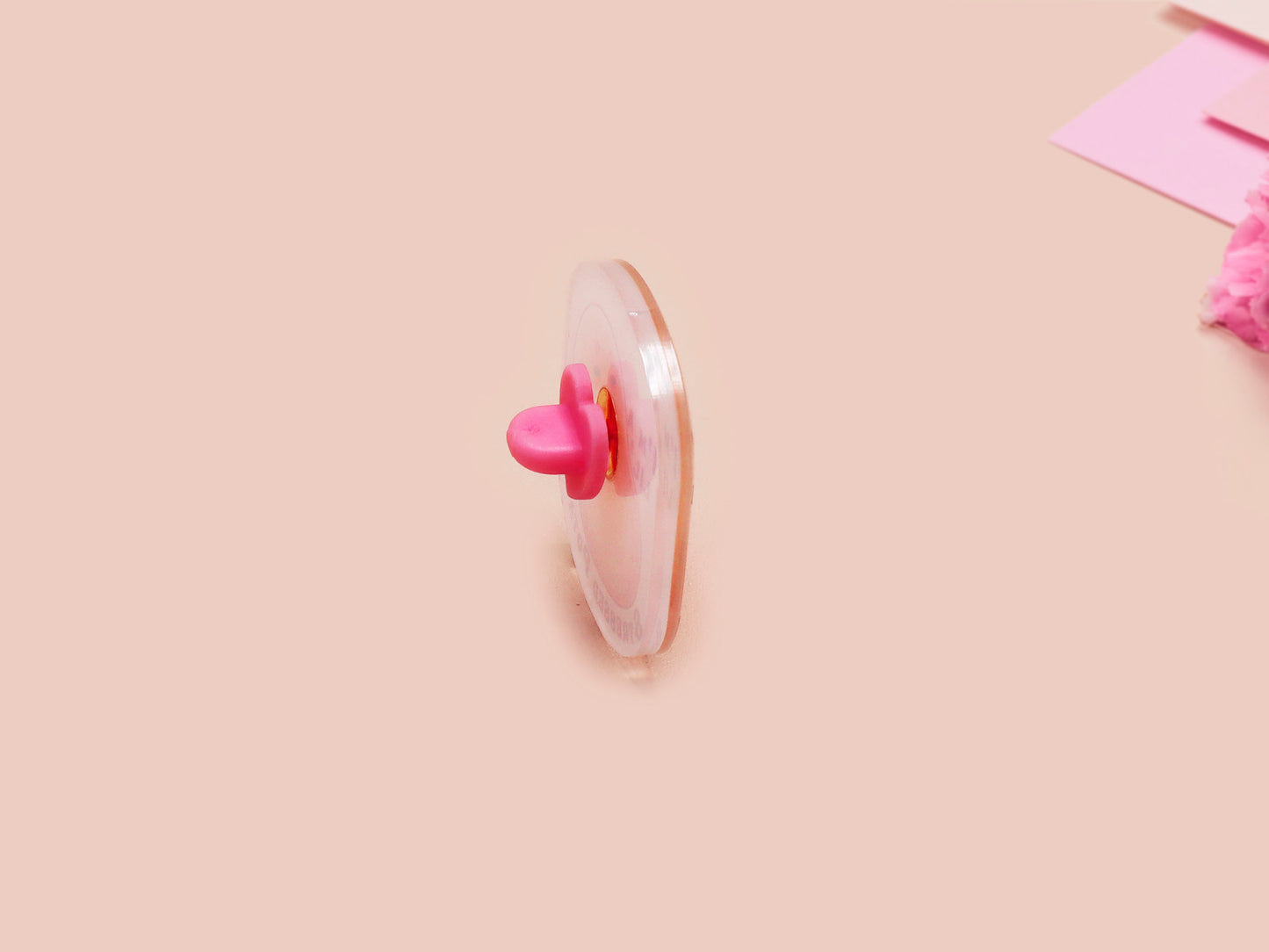 A clear acrylic pin badge with a pink heart-shaped pin back clasp. The design of the pin badge is of a cute chibi potato with the quote I'm a lil' stressed potato