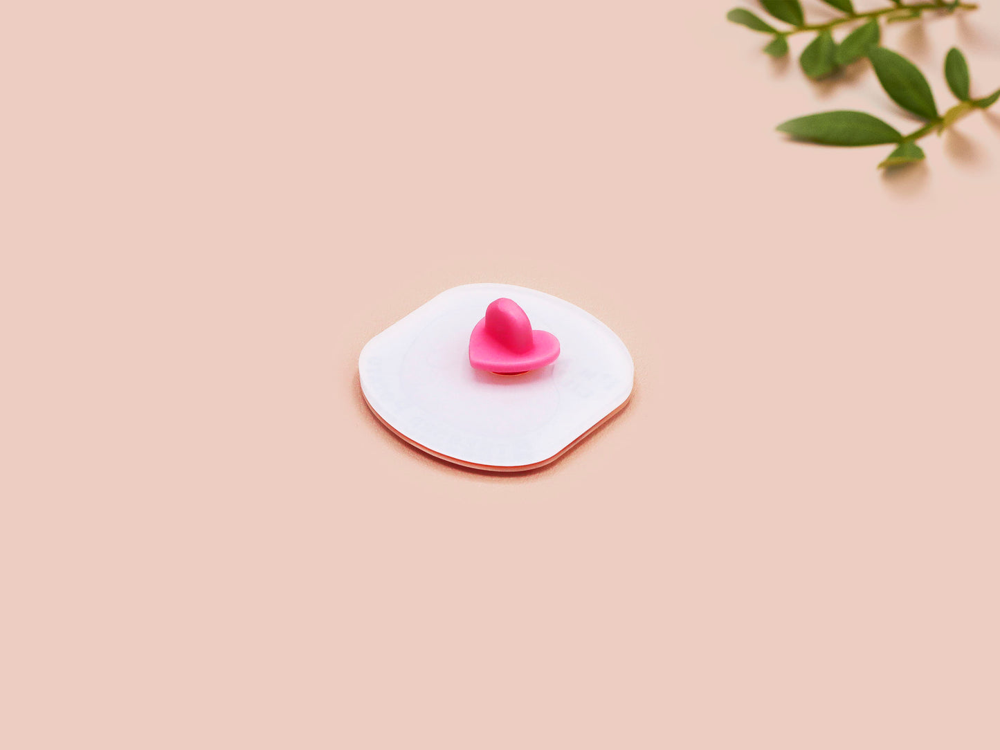 A clear acrylic pin badge with a pink heart-shaped pin back clasp. The design of the pin badge is of a cute chibi potato with the quote I'm a lil' stressed potato