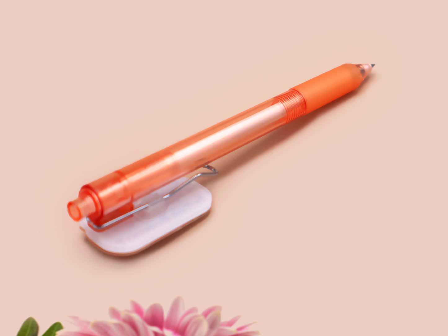 Orange ballpoint pen with black ink and a cute chibi dachshund sausage dog design.