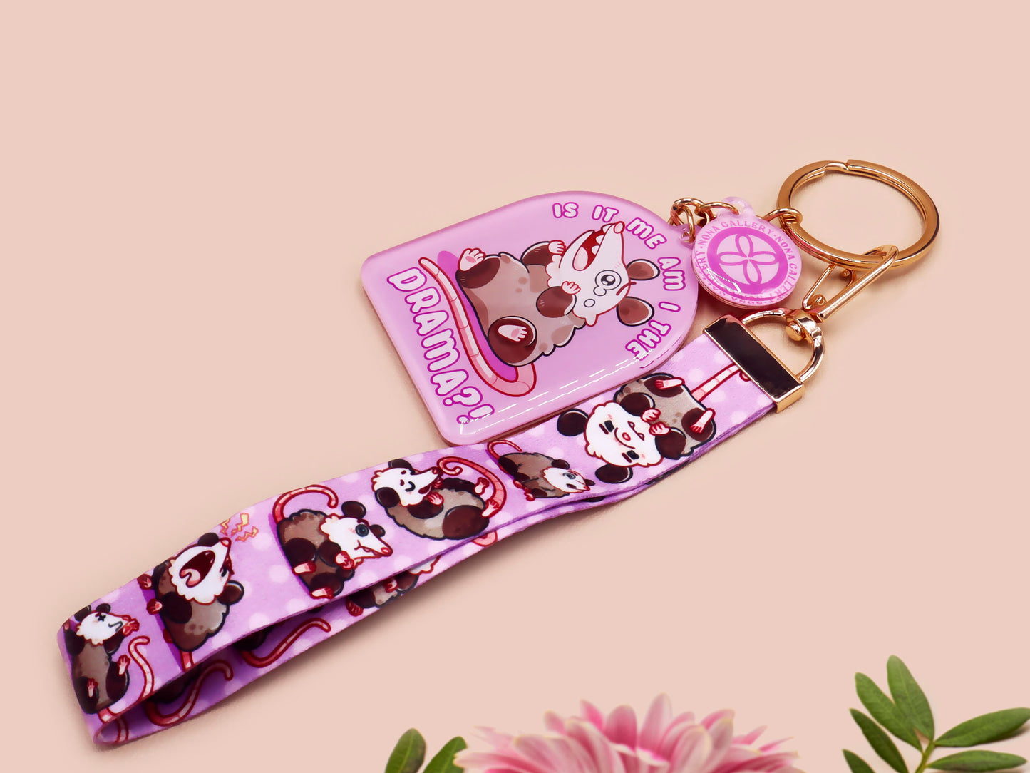 Acrylic epoxy possum keychain with a large acrylic charm of a purple screaming possum with the quote is it me am I the drama, a smaller charm of a cute crying possum and a matching purple possum lanyard.