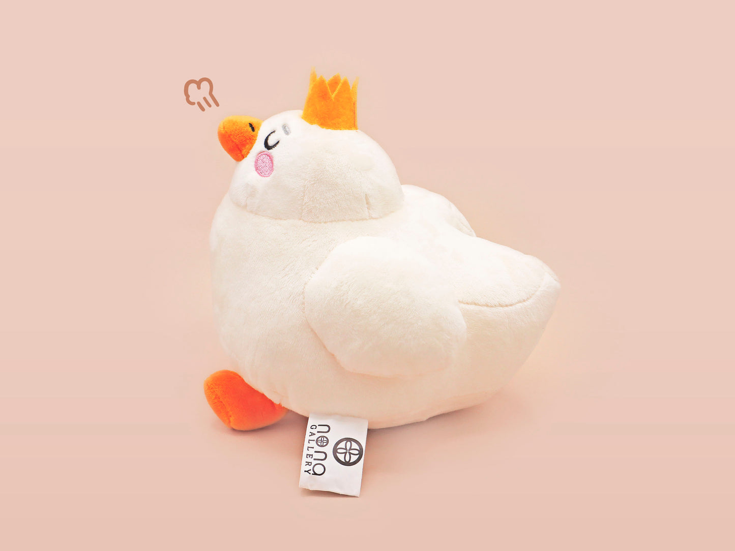 An adorable white duck bird plushie toy with cute embroidered eyes and facial expression, wearing a yellow crown hat, with a hang tag describing the duck as King Larry.