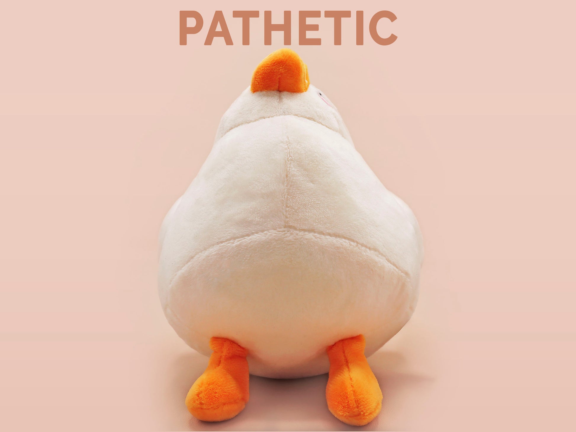 An adorable white duck bird plushie toy with cute embroidered eyes and facial expression, wearing a yellow crown hat, with a hang tag describing the duck as King Larry.