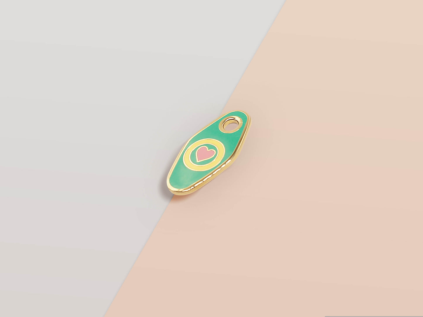 Mini Talisman charm with green, yellow and pink heart design, gold details and a small loop hole.