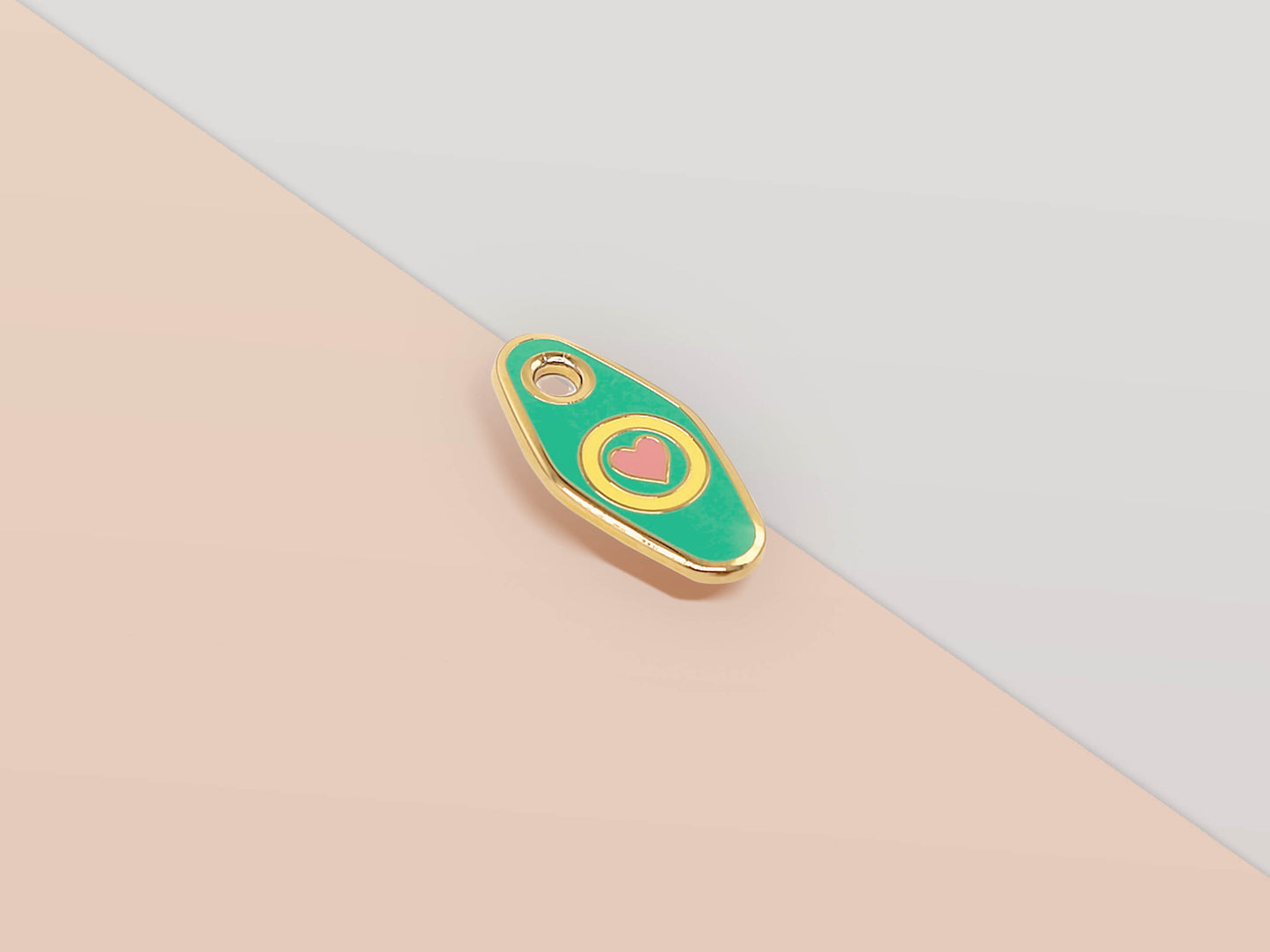 Mini Talisman charm with green, yellow and pink heart design, gold details and a small loop hole.