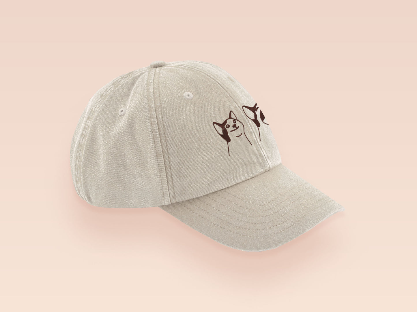 A cream baseball cap hat with an embroidered cute brown Popcat meme cat design.