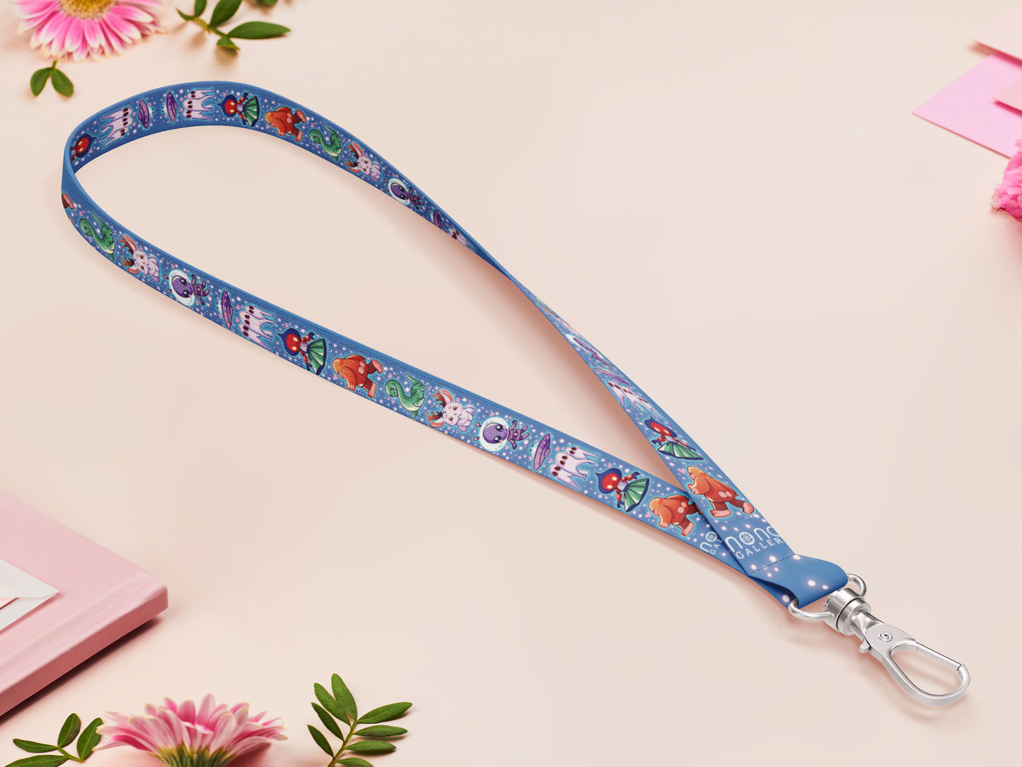 Cute full legth dark blue lanyard with a double sided cryptid monster and alien pattern and silver swivel hook clasp.