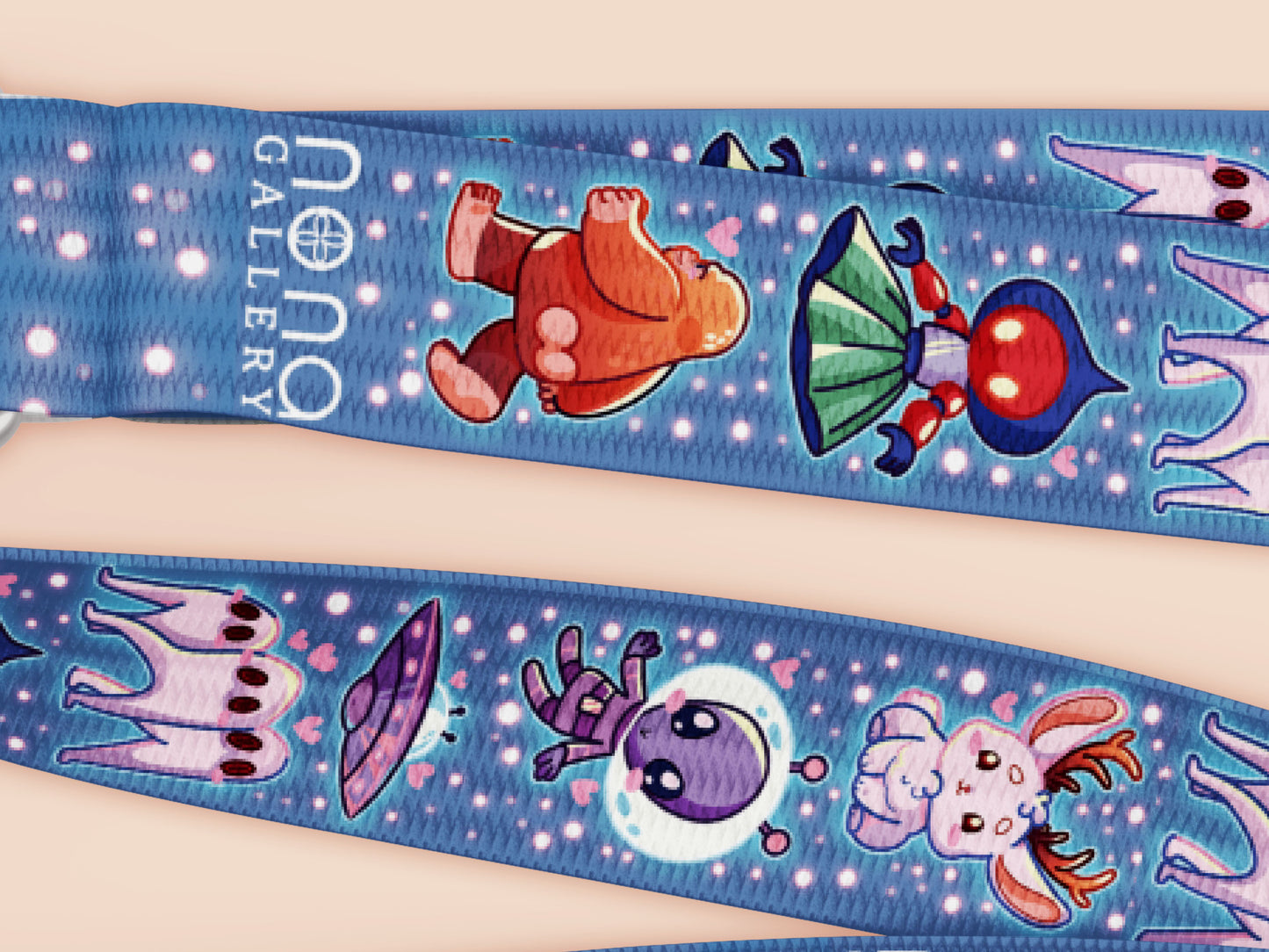 Cute full legth dark blue lanyard with a double sided cryptid monster and alien pattern and silver swivel hook clasp.