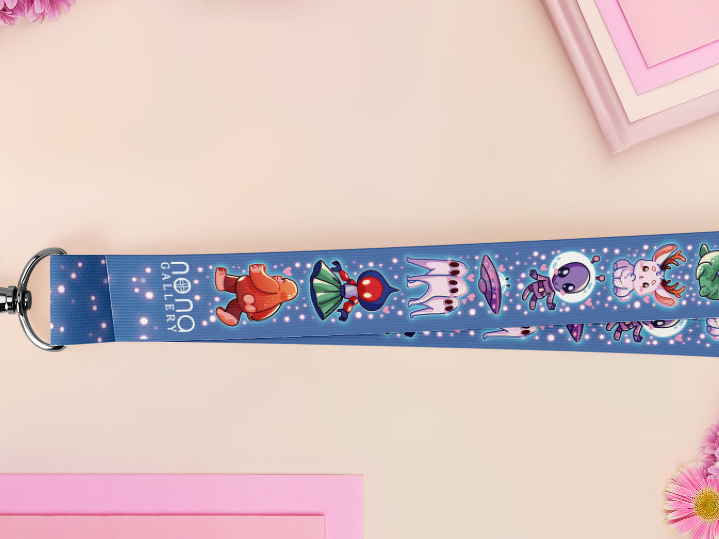 Cute full legth dark blue lanyard with a double sided cryptid monster and alien pattern and silver swivel hook clasp.