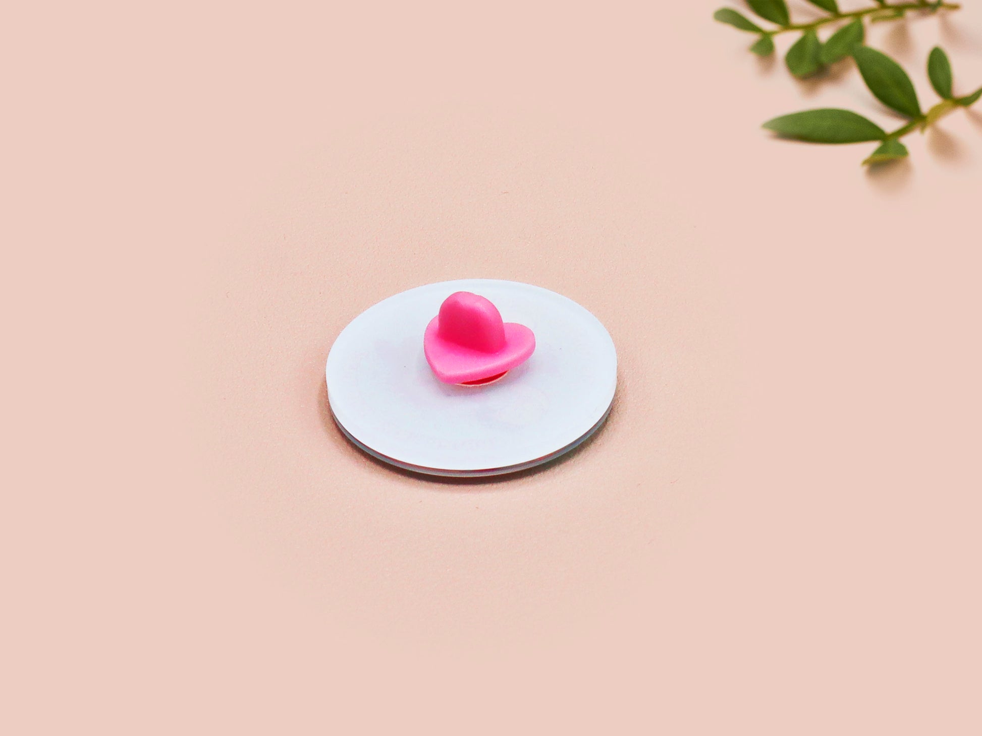 A clear acrylic pin badge with a pink heart-shaped pin back clasp. The design of the pin badge is of a cute chibi shrimp in a chefs outfit cooking with the quote So you're telling me a shrimp fried this rice?