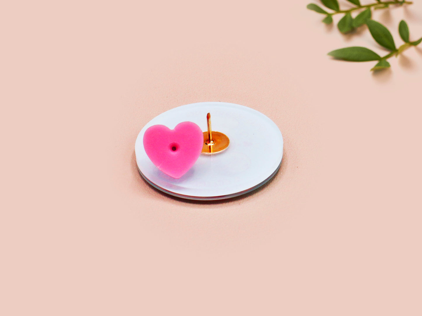 A clear acrylic pin badge with a pink heart-shaped pin back clasp. The design of the pin badge is of a cute chibi shrimp in a chefs outfit cooking with the quote So you're telling me a shrimp fried this rice?