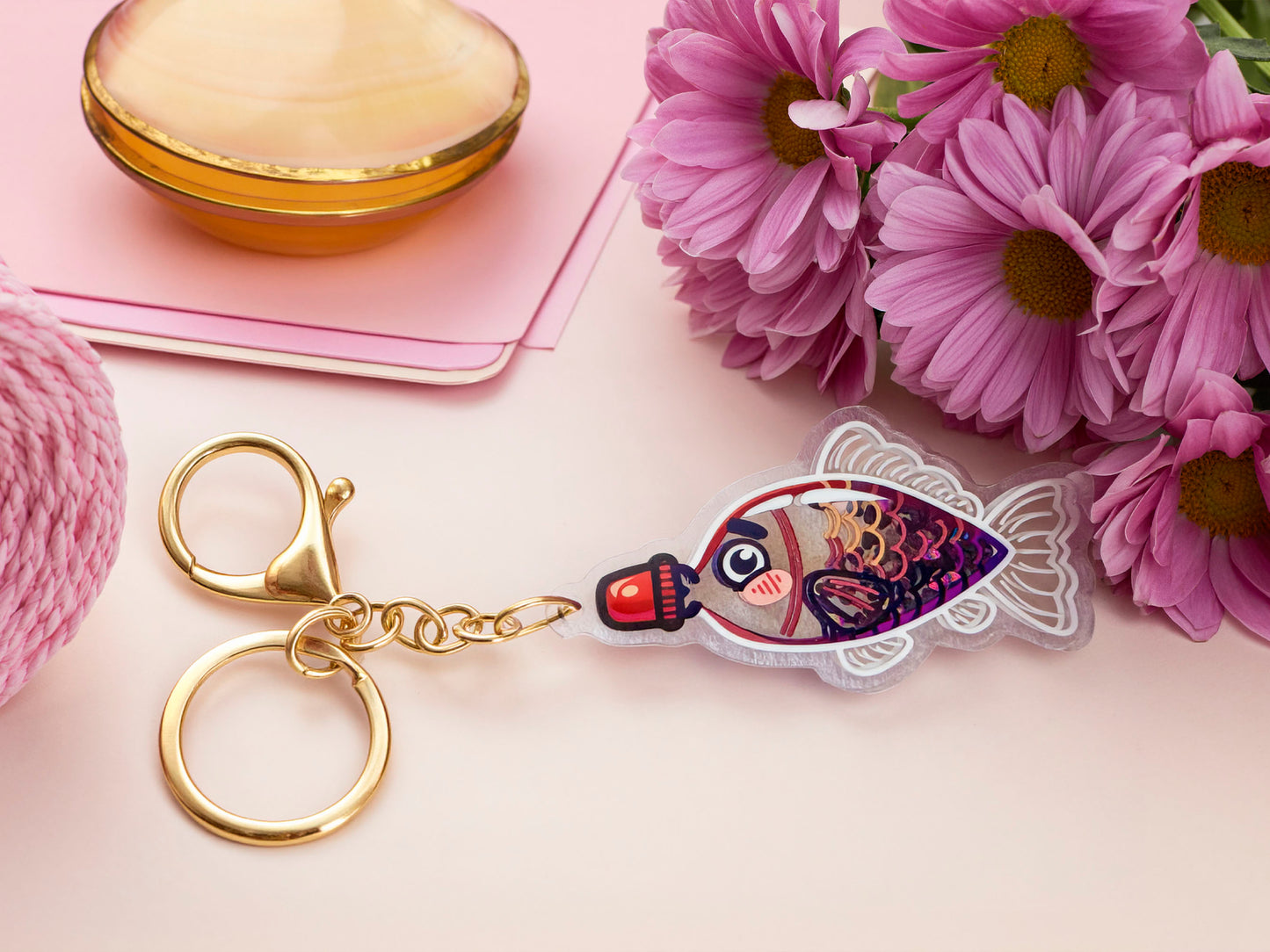 A large transparent acrylic shaker keychain with gold keyring, shaped like a traditional cute chibi soy sauce fish bottle and filled with liquid black gliter and confetti