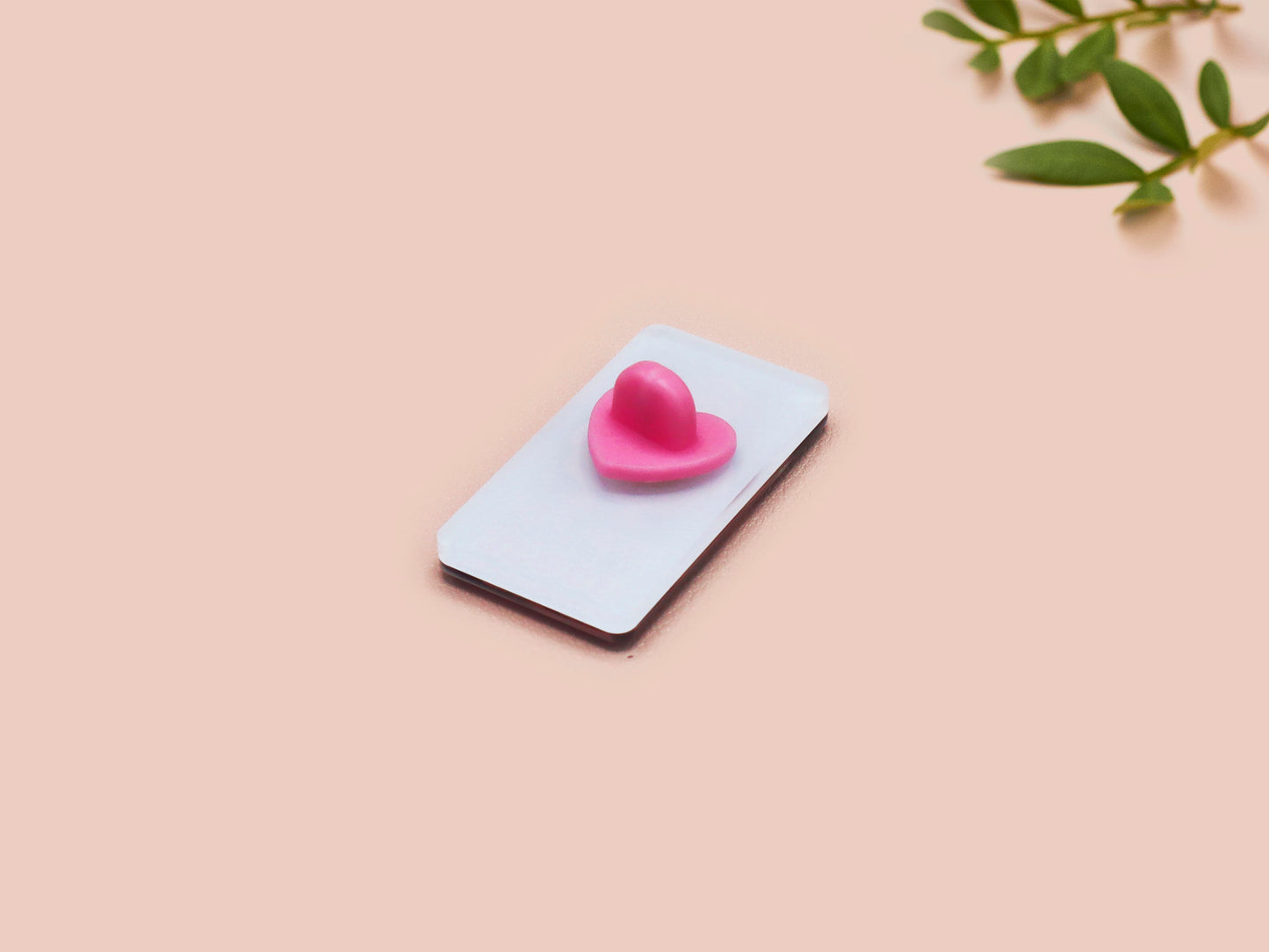 A black acrylic pin badge with a pink heart-shaped pin back clasp. The design of the pin badge is of a cute goose in a shirt and tie with the quote Time For Serious Goose