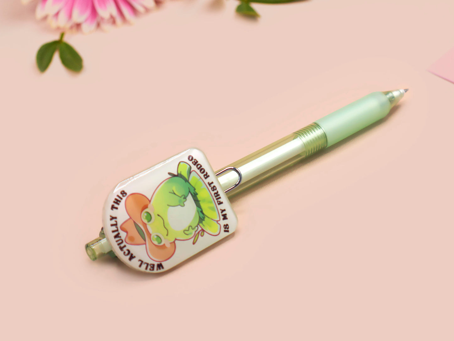 Green ballpoint pen with black ink and a cute chibi cowboy frog design.