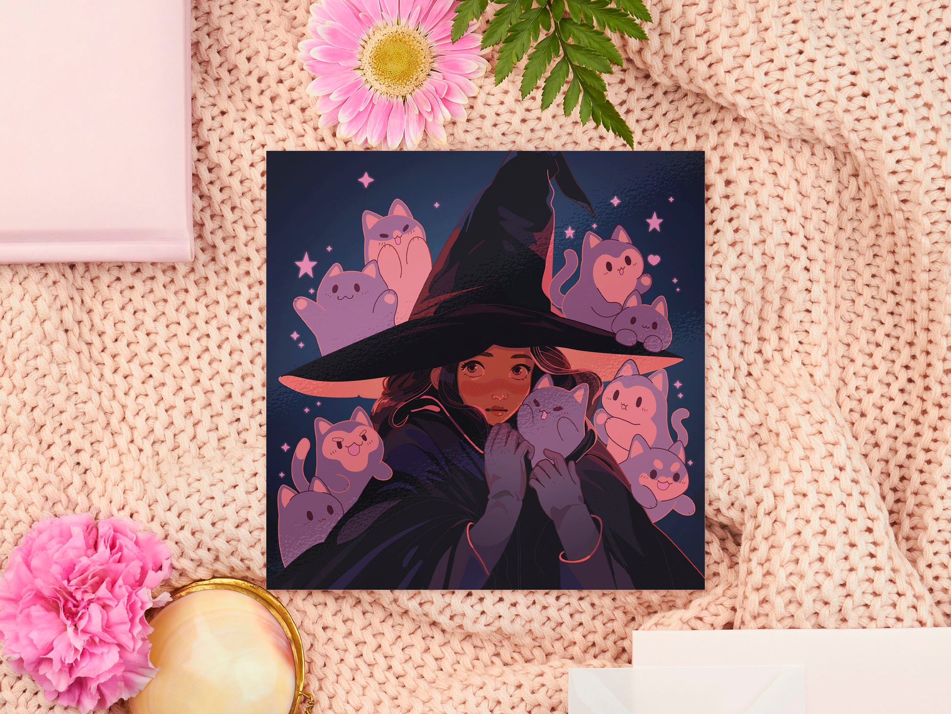 Square art print of a young witch wearing a large glowing witch's hat surrounded by nine cute chibi ghost cats.