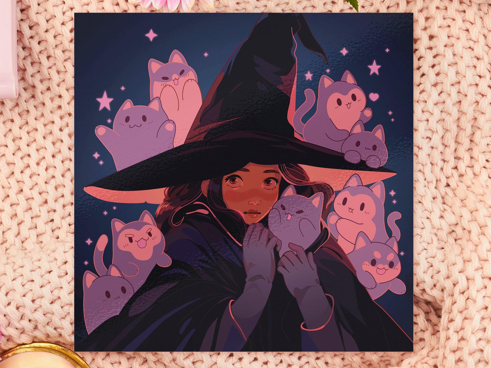 Square art print of a young witch wearing a large glowing witch's hat surrounded by nine cute chibi ghost cats.