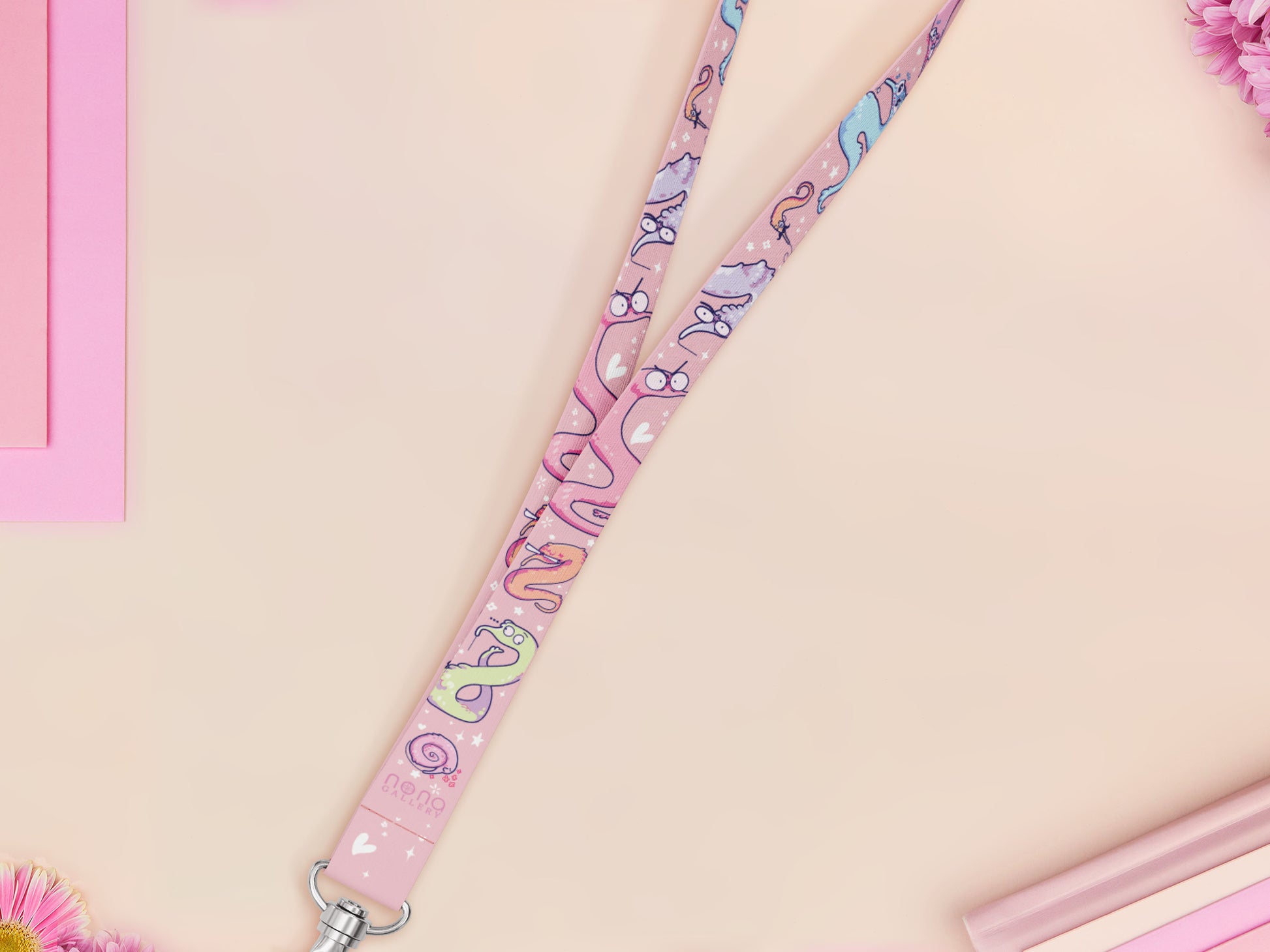 Cute full legth pink lanyard with a double sided funny worm on a string pattern and silver swivel hook clasp.
