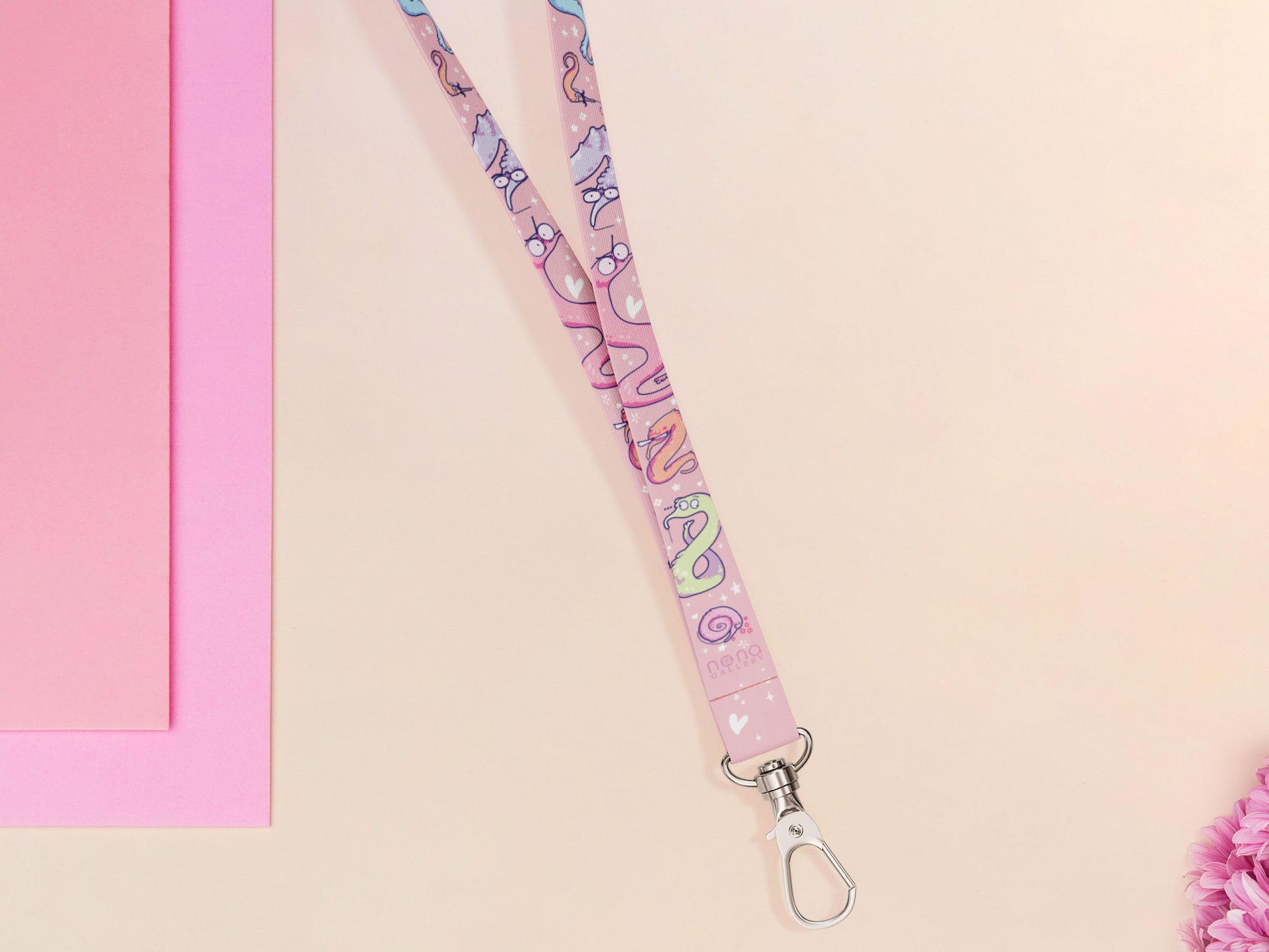Cute full legth pink lanyard with a double sided funny worm on a string pattern and silver swivel hook clasp.