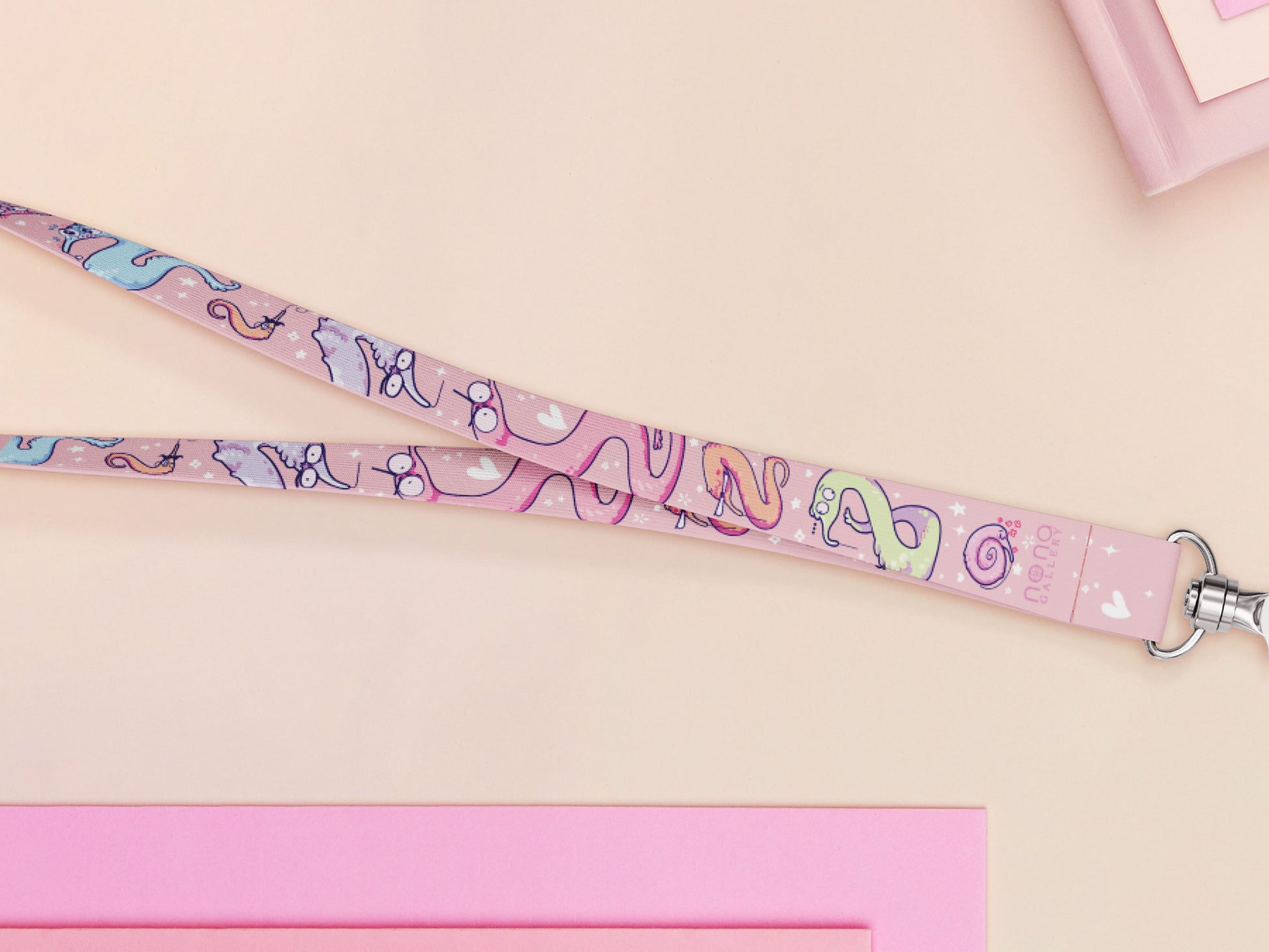 Cute full legth pink lanyard with a double sided funny worm on a string pattern and silver swivel hook clasp.