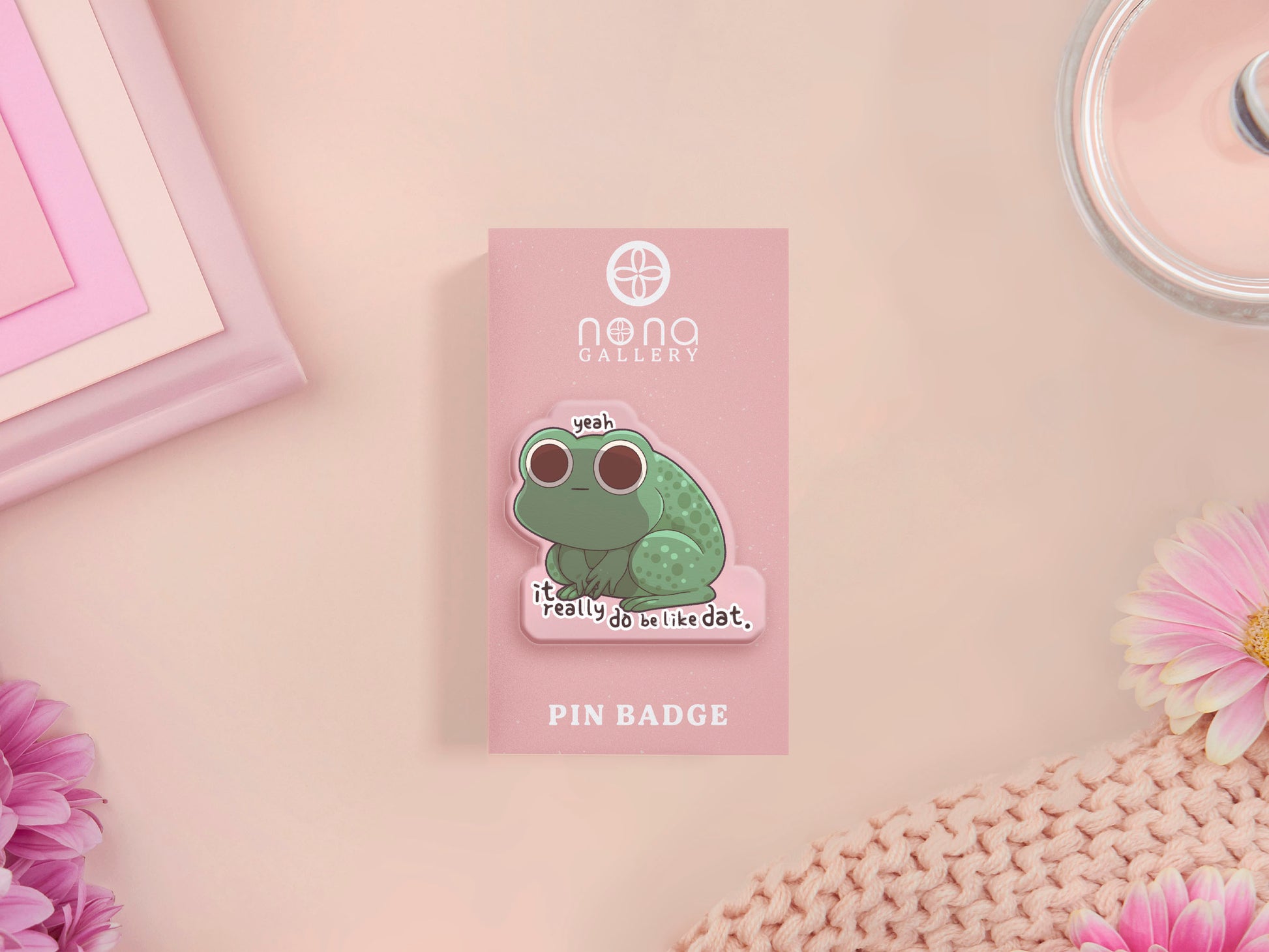 Clear acrylic pin badge with a pink heart-shaped rubber pin back clasp. The design of the pin badge is a cute cartoon stressed frog with the quote yeah it really do be like dat.