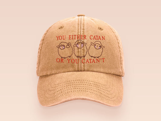 A vintage yellow baseball cap hat with an embroidered cute chibi sheep with the quote you either catan or you catan't