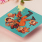 Square art print depicting a young astronaut firing a ray gun, while three adorable cats in spacesuits react.