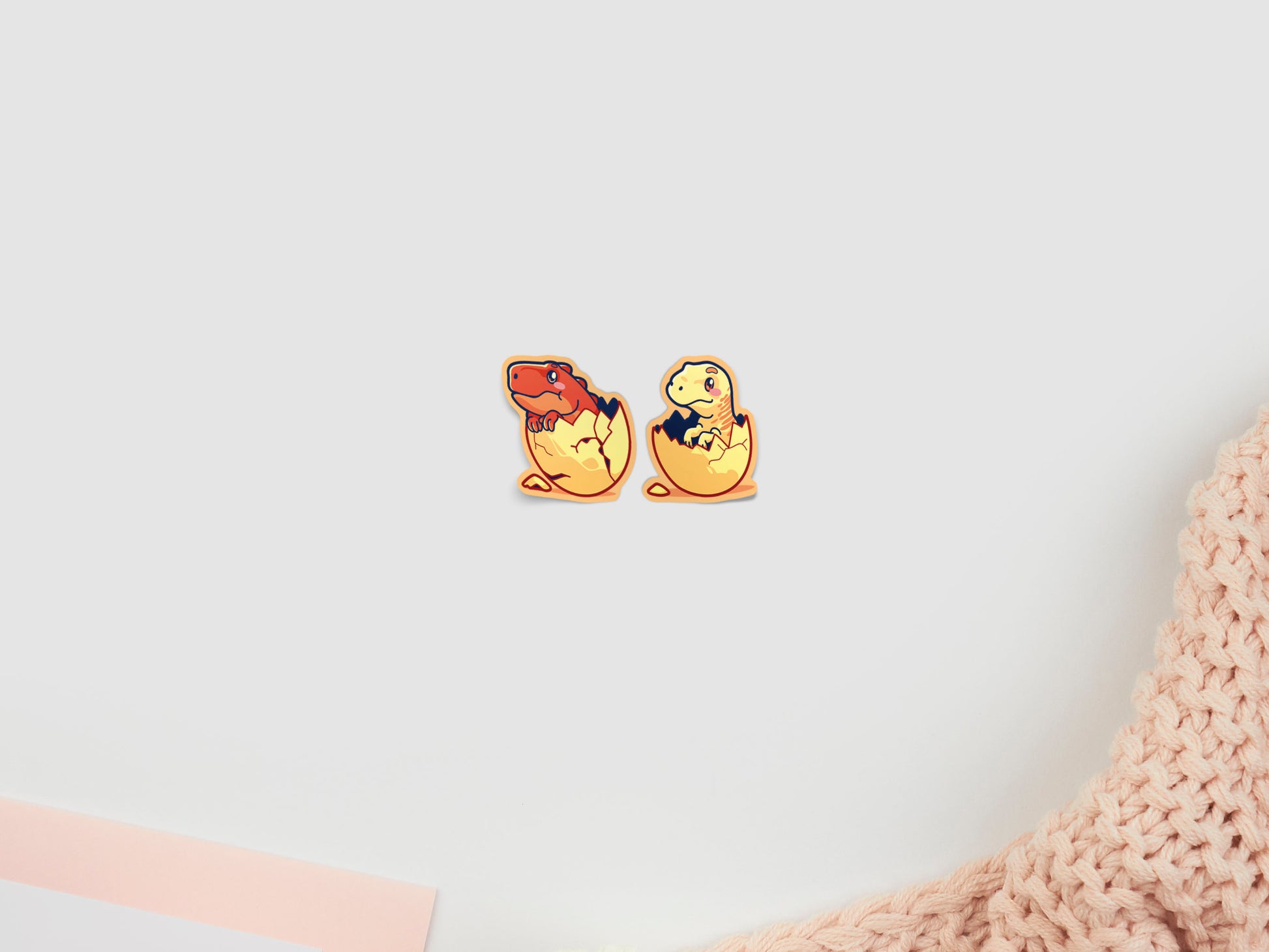 Two baby dinosaur stickers hatching from eggs