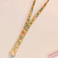 Cute full legth yellow lanyard with a double sided baby dinosuras hatcing from eggs pattern and silver swivel hook clasp.