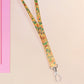 Cute full legth yellow lanyard with a double sided baby dinosuras hatcing from eggs pattern and silver swivel hook clasp.