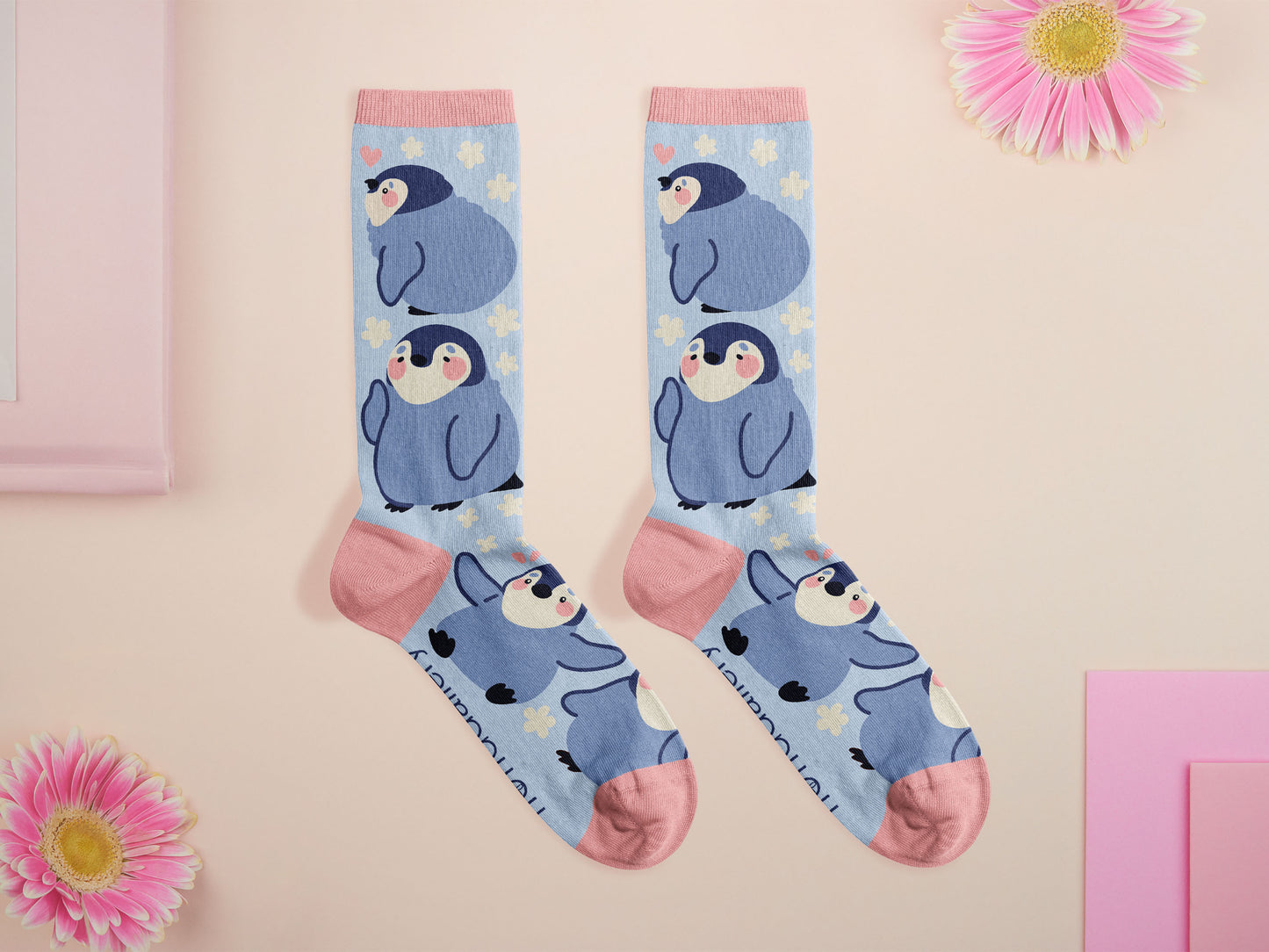 Cute knitted cotton crew socks with a cute baby emperor penguin design.