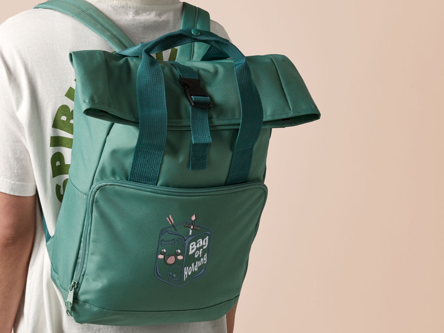 Green roll top twin handle backpack with an embroided design of cute gelatinous cube DND monster and the quote Bag of Holding