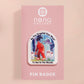 Clear acrylic pin badge with pink heart-shaped rubber pin back clasp. The design of the pin badge is a cute cartoon chibi fresno nightcrawlers, yeti bigfoot and alien UFO in a forest with the quote Be The Cryptid You Want To See In The Woods.