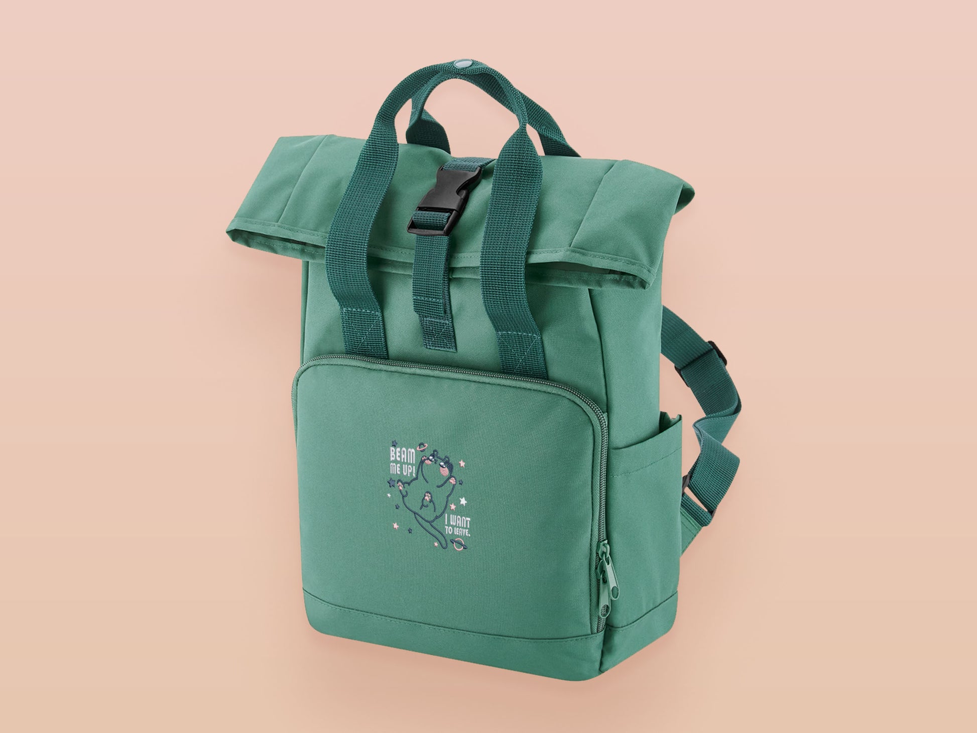 Green roll top twin handle backpack with an embroided design of cute space alien cat floating in the stars and the quote beam me up I want to leave!