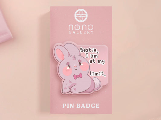 A cute transparent acrylic pin badge with a pink heart-shaped rubber clasp pin back of a chibi bunny rabbit crying with the text Bestie I am at my limit