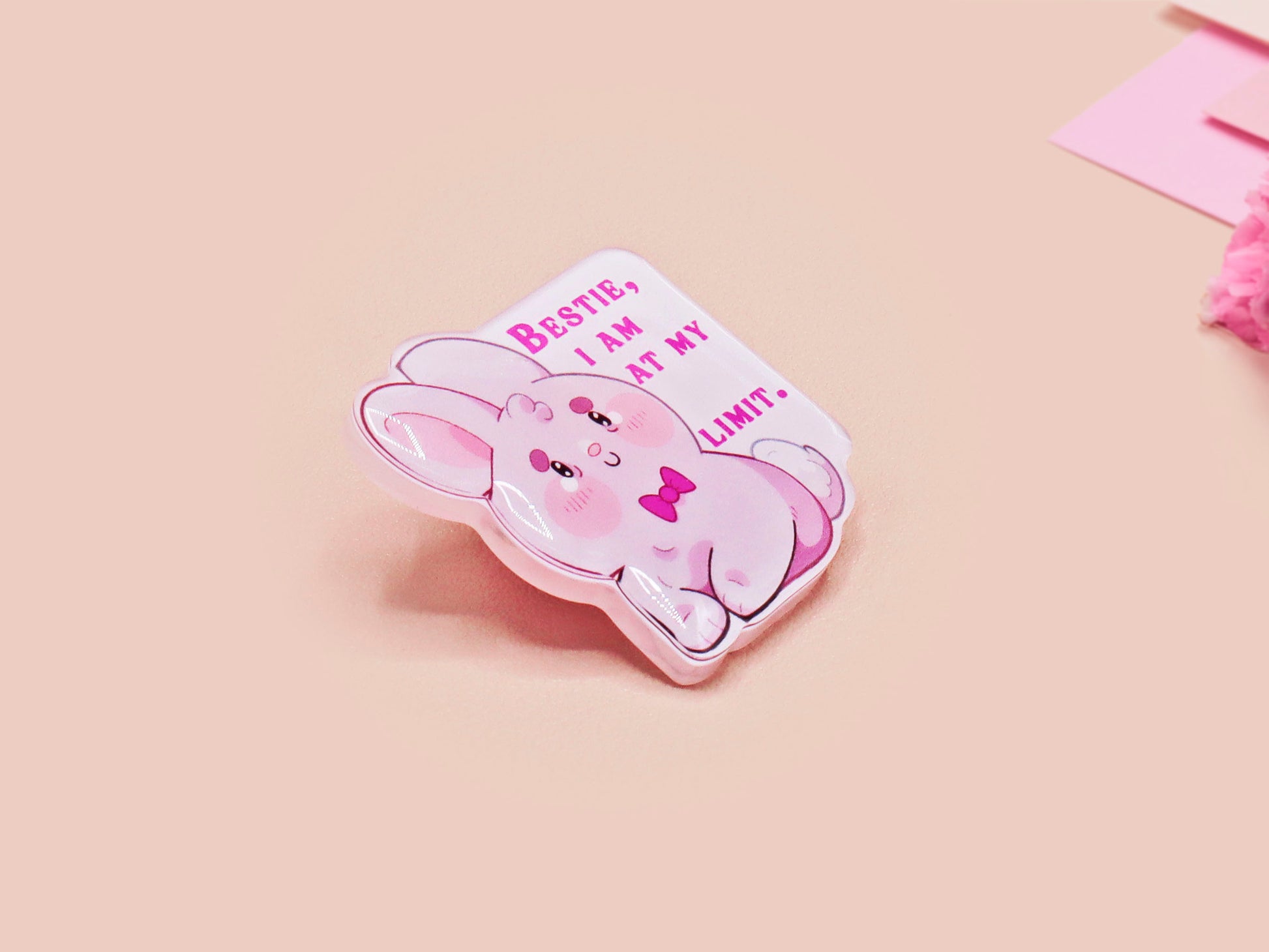 A cute transparent acrylic pin badge with a pink heart-shaped rubber clasp pin back of a chibi bunny rabbit crying with the text Bestie I am at my limit