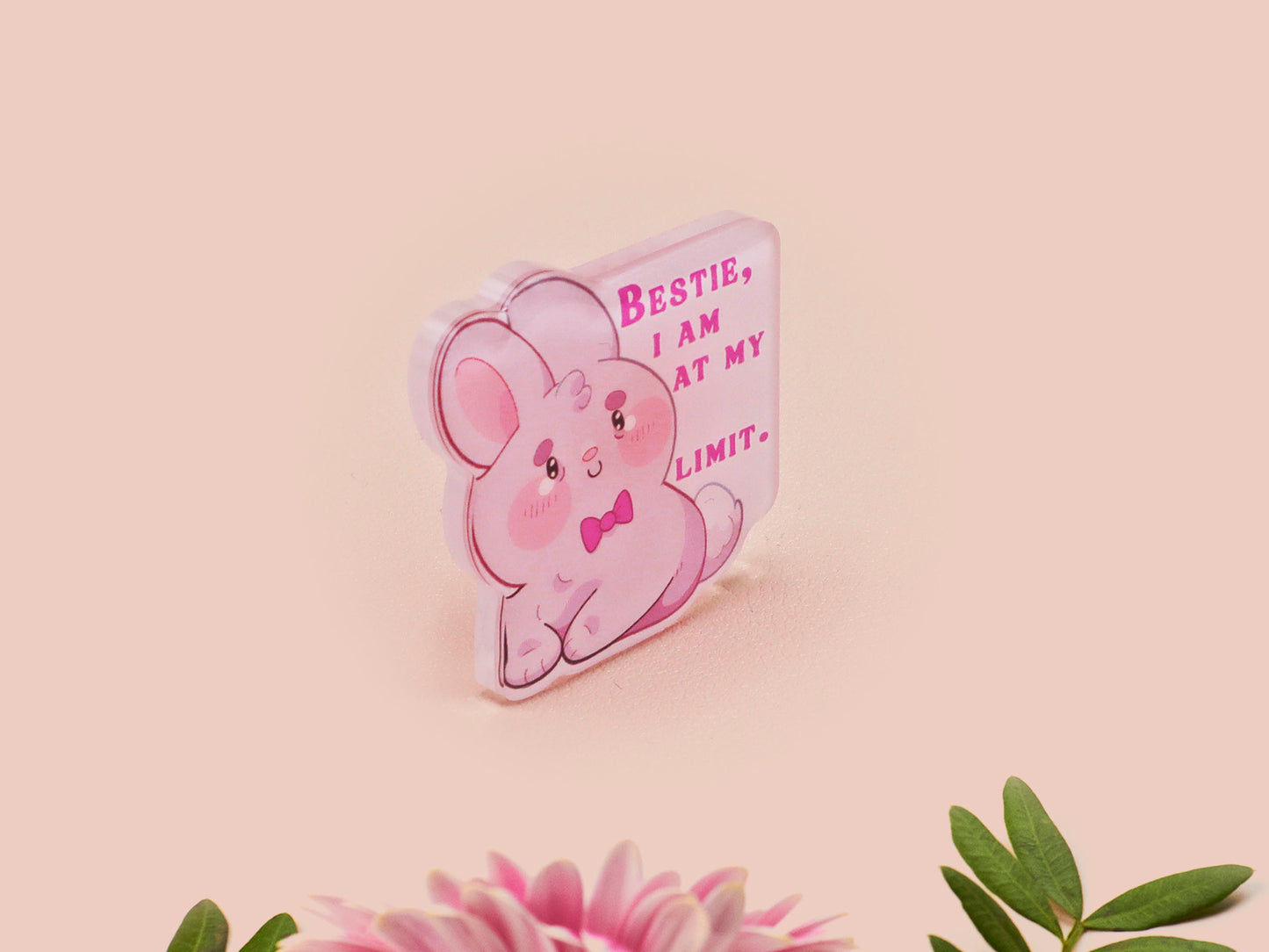 A cute transparent acrylic pin badge with a pink heart-shaped rubber clasp pin back of a chibi bunny rabbit crying with the text Bestie I am at my limit