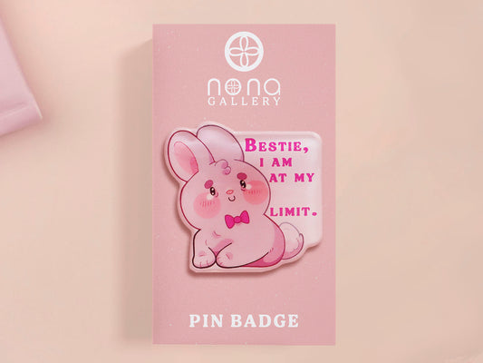 A cute transparent acrylic pin badge with a pink heart-shaped rubber clasp pin back of a chibi bunny rabbit crying with the text Bestie I am at my limit