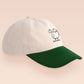 Vintage contrast cream and green peek baseball cap with an embroidered design of a cartoon bird and the quote bird brain.