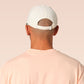 Vintage contrast cream and green peek baseball cap with an embroidered design of a cartoon bird and the quote bird brain.