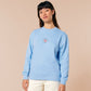 A blue long sleeve sweater, with an embroidered chibi shrimp looking concerned and the quote Not so shrimple is it?