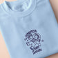 T-shirt with an embroidered blue design of a cute chibi astronaut surrounded by the funny quote Houston I have so many problems