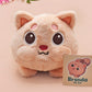 An adorable fluffy cat plushie toy with cute embroidered eyes, facial expression and applique stripes, with a hang tag describing the cat as Brenda.