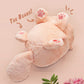 An adorable fluffy cat plushie toy with cute embroidered eyes, facial expression and applique stripes and pawprint toe beans, with a hang tag describing the cat as Brenda.