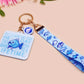 Acrylic epoxy underwater fish keychain with a large acrylic charm of a blue fish with the quote buy a man eat fish he day teach fish man to a lifetime, a smaller charm of a cute fish and a matching underwater lanyard.