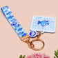 Acrylic epoxy underwater fish keychain with a large acrylic charm of a blue fish with the quote buy a man eat fish he day teach fish man to a lifetime, a smaller charm of a cute fish and a matching underwater lanyard.
